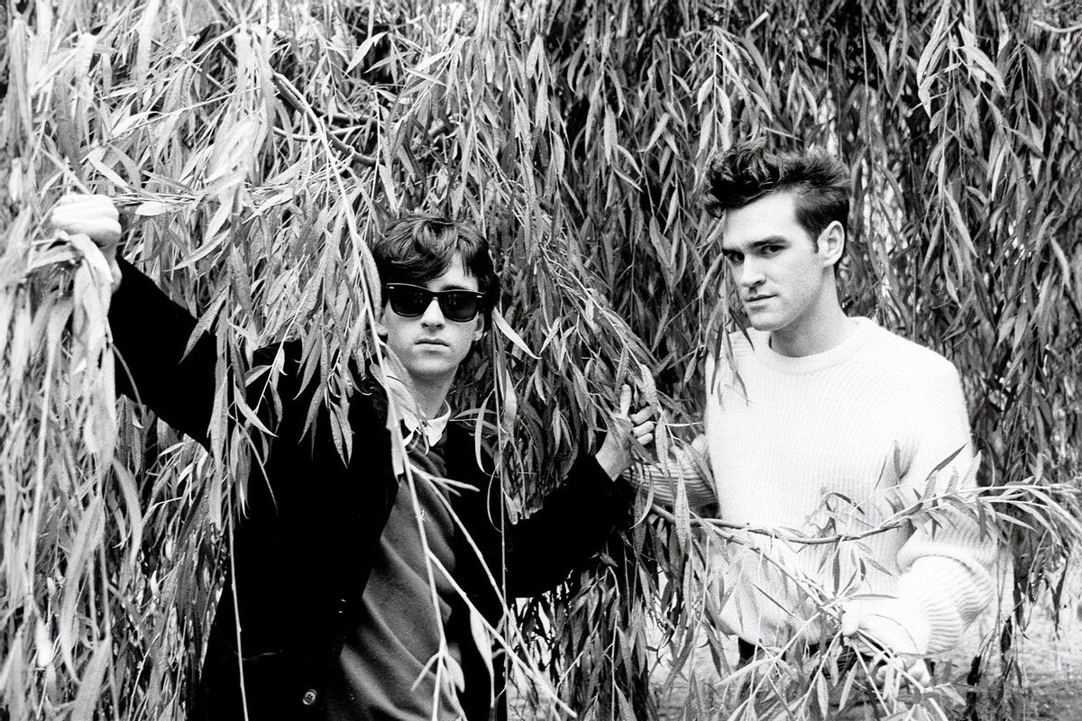 Johnny Marr (left) and Morrissey of the group The Smiths pose under the branches of a willow tree in London in 1983. (Clare Muller/Redferns/Getty Images)