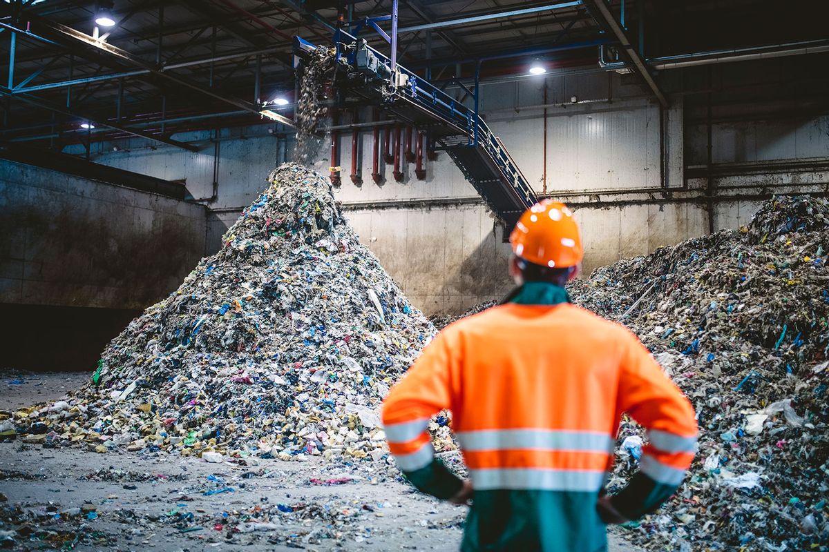 Worker Observing Processing of Waste at Recycling Facility (Getty Images/AzmanJaka)